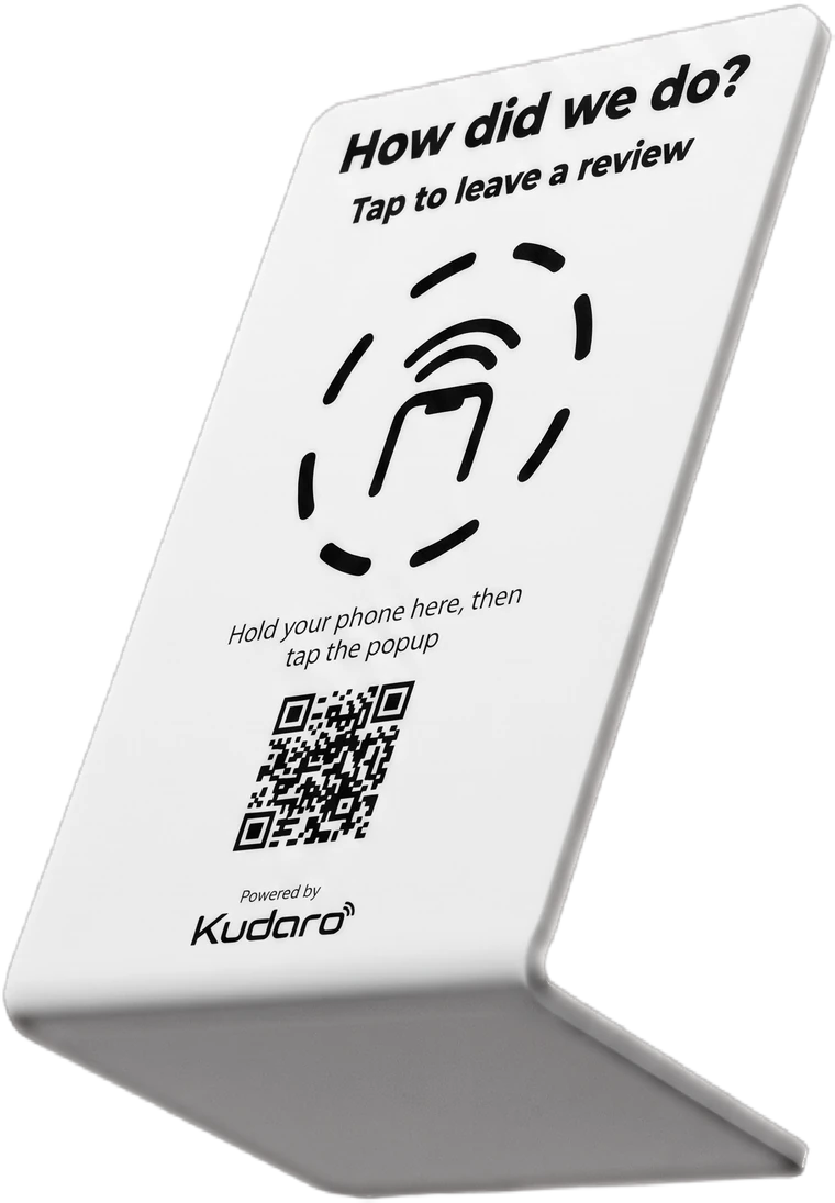 A Kudaro tap-to-review placard standing on a counter, reading "How did we do? Tap to leave a review."